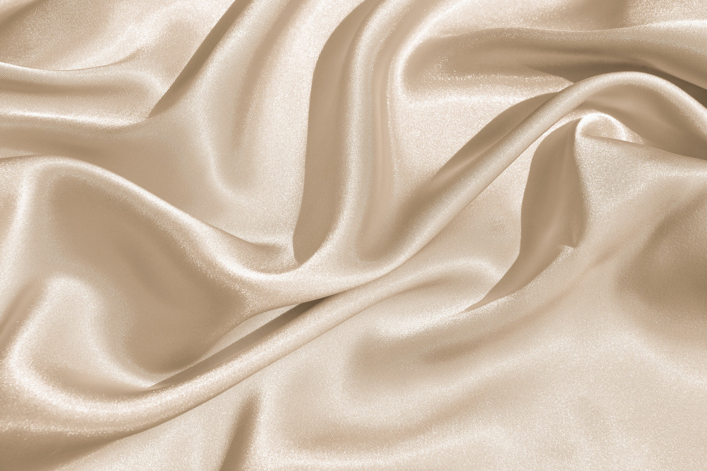 The texture of the satin fabric of beige color